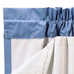 the bottom half of a pair of blue and white curtains with zippers on them