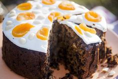 a cake with white frosting and orange slices