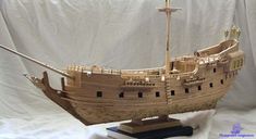 a wooden model of a pirate ship on display