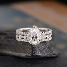 a close up of a diamond ring on a rock