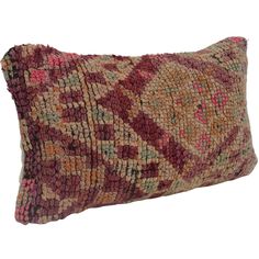 a decorative pillow that is made out of various colors and shapes, with an intricate design on