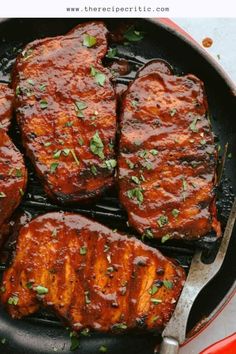 steaks are cooking in a skillet with tongs and garnishes