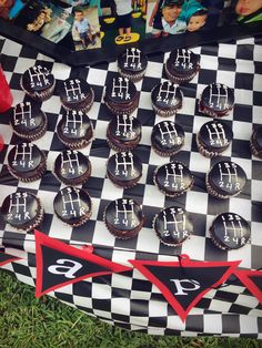 cupcakes are arranged in the shape of chess pieces on a checkered board