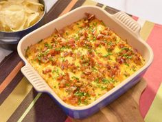 a casserole dish with broccoli and cheese in it on a table