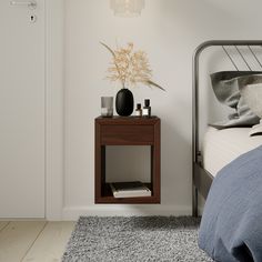 a bedroom with a bed, nightstand and plant on the side table next to it