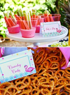 there are some candy and pretzels on the table with place cards in them