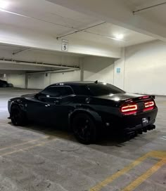 a black sports car parked in a parking garage