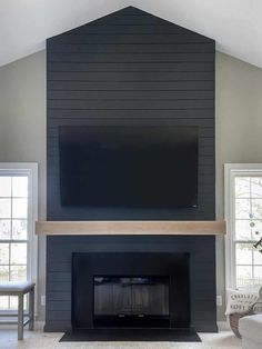 a living room with a fireplace and television mounted on the wall