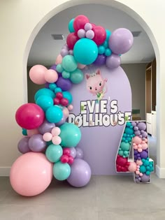 an entrance decorated with balloons and streamers for a children's birthday or baby shower