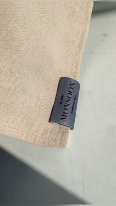 a label on the side of a tan shirt