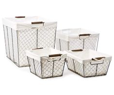 four white storage baskets with handles