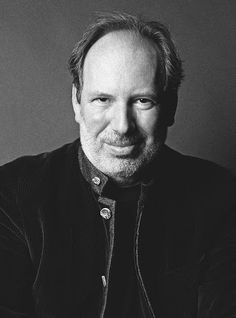 a black and white photo of a man smiling