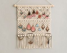 a wall hanging with earrings on it