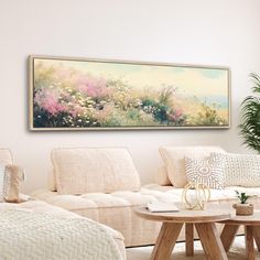 a living room filled with furniture and a painting on the wall