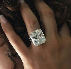 a woman's hand with a diamond ring on it