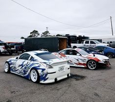 some very nice looking cars in a parking lot