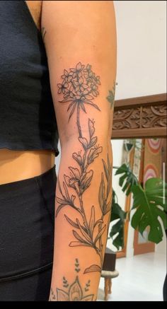 a woman with a flower tattoo on her arm