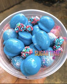 a plastic container filled with blue frosted desserts