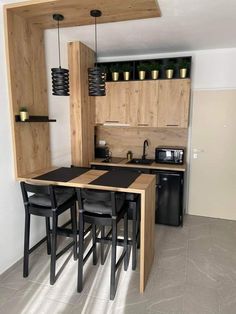 a kitchen with wooden cabinets and black chairs