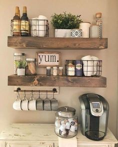 some shelves that have coffee cups and mugs on them with the words yum above them