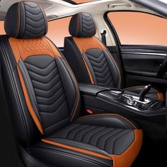 the interior of a car with black and orange leather seats