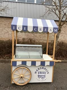 an ice cream cart sitting in front of a building