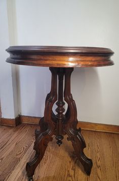 a wooden table sitting on top of a hard wood floor