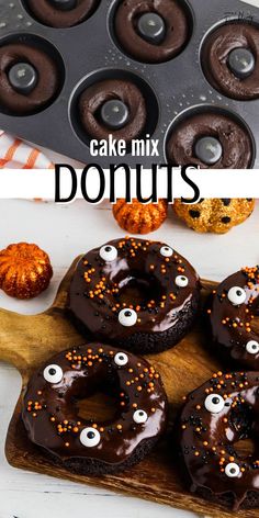 chocolate donuts decorated with googly eyes and sprinkles on a wooden cutting board