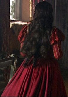 the back of a woman's head in a red dress