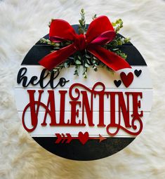 a wooden sign that says hello valentine with red bow on top and green plants in the middle