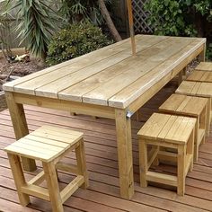 a wooden table and benches on a deck