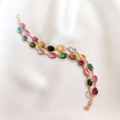 This stunning bracelet is set in 14k Solid Yellow Gold with Natural Multi Tourmaline. It is an unique and dainty gemstone earring bracelet for nearly every occasion and is completely hassle-free jewelry. ITEM DETAILS: * Gem: Multi Tourmaline * Gem Size: Fancy (22pcs) * Gem Shape: mix * Gem Weight: 20.17 carats * Gold Purity: 14KT * Gold Weight: 5.11 gram * Total Weight of the Earrings: 9.14 gram The Gold purity is guaranteed and it comes with authentic 14KT gold hallmark. Since my items are handmade, they are absolutely nickel and lead free. CUSTOMIZATION: * Same Bracelets are available in 14KT as well 18KT gold. Kindly choose your preferred gold purity from the drop-down option. * The Bracelets can be made in 14KT/18KT Yellow, White & Rose Gold. Kindly choose the gold color from the drop- Modern Gold Bracelet With Multi-stone, 14k Gold Bracelet With Gemstones, Fine Jewelry, Elegant Tourmaline Bracelets As Gift, Elegant Adjustable Tourmaline Jewelry, Gold Tourmaline Bracelet Jewelry, Gold Bracelets With Natural Stones And Tourmaline, Elegant Tourmaline Bracelets For Gift, Gold Multi-stone Bracelets For Gifts, Elegant Tourmaline Bracelet For Gift