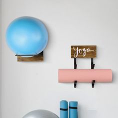 there is a yoga mat and exercise ball on the wall