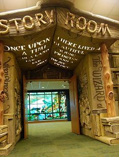 an entrance to a restaurant with carved wooden pillars and windows in the front, along with writing on the walls