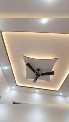 a ceiling fan is mounted to the ceiling in a room with white walls and recessed lighting