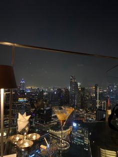 a rooftop bar overlooking the city at night