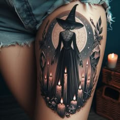 a woman's thigh with an image of a witch on it and candles in the background