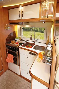 a kitchen area with sink, stove and oven inside of a small house or rv