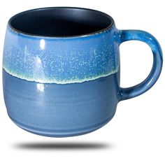 a blue and white coffee cup with water on it's rim, sitting in front of a white background