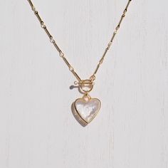 "C R Y S T A L ∙ H E A R T ∙ N E C K L A C E A classic heart shaped clear quartz pendant on a gold plated brass toggle chain. Clear quartz is known for it's healing properties: Healing, Cleansing, and Intuition. * Design: Crystal Heart Pendant - Toggle Chain Necklace * Material & Finish: Gold Plated Brass * Pendant: Clear Quartz Heart Pendant - Gold Plated Brass Frame * Pendant Size (Approx.): 20mm | 0.8 in * Necklace Length - 2 Options: 17in, 22in ** Your necklace may vary slightly due to the uniqueness of the stone B I R TH S T O N E ∙ A N D ∙ Z O D I A C * Birthstone: April * Zodiac: Aries, Taurus Clear quartz is a versatile and widely loved stone. It's known as the \"master healer\" and amplifies the energy of other stones. It enhances the determination of Aries and the practicality of Clear Heart Charm Necklace With Heart Pendant, Clear Heart Charm Necklace, Heart Pendant Necklace Gold, Clear Quartz Necklace, Crystal Heart Pendant, Toggle Necklace, Heart Pendant Gold, Gold Heart Necklace, Pretty Necklaces