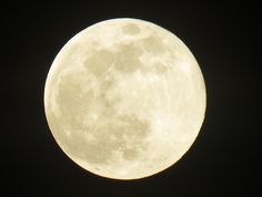 the full moon is shining bright in the dark sky