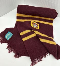 a harry potter scarf with a badge on it