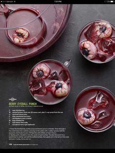 three glasses filled with liquid and fruit on top of a black table next to a red tray