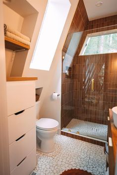 a bathroom with a toilet, sink and shower in it's own area is shown