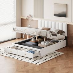 a white bed sitting on top of a wooden floor