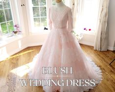 a dress on display in front of a window with the words, blush wedding dress