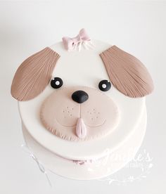 a cake decorated with a dog's face and ears