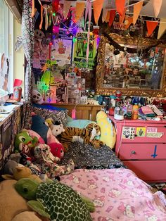 a room filled with lots of stuffed animals and decorations hanging from the ceiling above it