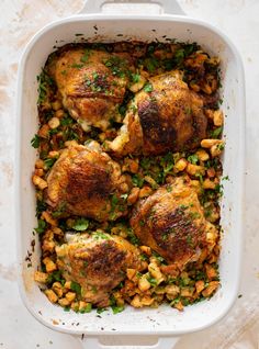 chicken and corn casserole in a white dish with parsley sprinkled on top