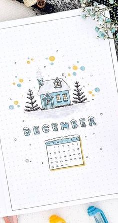 a calendar with the words december written on it next to crayons and markers